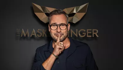 Matthias Opdenhövel vor dem Logo von The Masked Singer