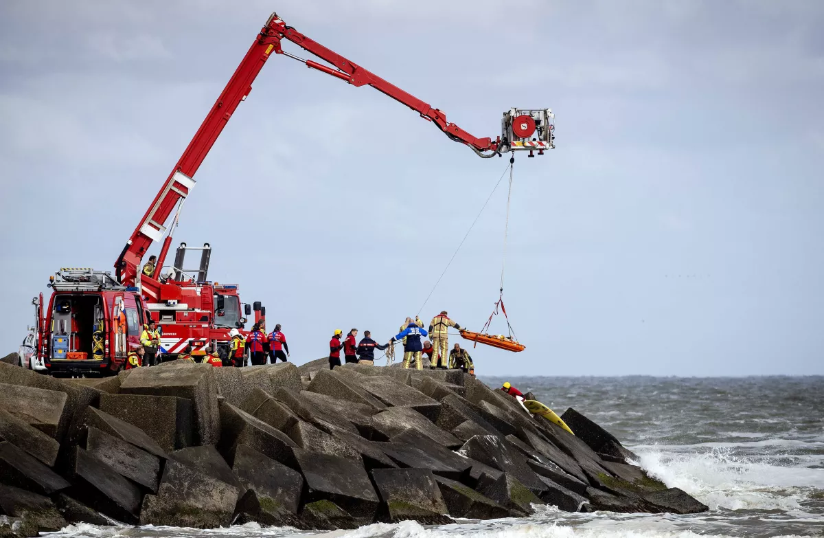 Rettungskräfte bergen eine Leiche, die sie bei der erneuten Suche nach den vermissten Wassersportlern im Noordelijk Havenhoofd gefunden haben